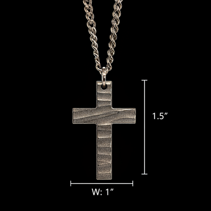 Silver cross pendant necklace with measurements on a black background